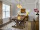 Dining room featuring a large wooden table, stylish lighting, and bright window at 502 Pontoon Rd, Huger, SC 29450