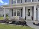 Close-up of the cozy front porch with white columns and a charming bench at 502 Pontoon Rd, Huger, SC 29450