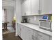 Kitchen counter with stainless steel microwave and white cabinets at 502 Pontoon Rd, Huger, SC 29450