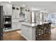 Spacious kitchen featuring an island with seating, stainless steel appliances, and access to an outdoor patio at 502 Pontoon Rd, Huger, SC 29450