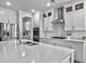Bright kitchen featuring white cabinets, stainless steel appliances, and a large island with a sink at 502 Pontoon Rd, Huger, SC 29450