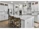 Spacious white kitchen featuring stainless steel appliances, an island with seating, and ample cabinet space at 502 Pontoon Rd, Huger, SC 29450