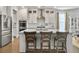 Bright kitchen featuring white cabinets, stainless steel appliances, and a large island with seating at 502 Pontoon Rd, Huger, SC 29450