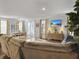 Open-concept living room with a comfortable sofa, dining area, and access to an outdoor patio at 502 Pontoon Rd, Huger, SC 29450