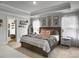 Spacious main bedroom features a king-sized bed, tray ceiling, and natural light from windows with blinds at 502 Pontoon Rd, Huger, SC 29450