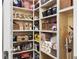 Walk-in pantry featuring organized shelving with various food items and storage containers at 502 Pontoon Rd, Huger, SC 29450