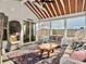Cozy screened porch offering ample seating, a unique coffee table, and serene views at 502 Pontoon Rd, Huger, SC 29450