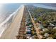 Aerial view of expansive coastline with beach homes along a pristine beach and winding roads at 511 W Ashley Ave, Folly Beach, SC 29439