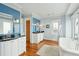 Bright bathroom featuring a dual sink vanity with great lighting, blue accent wall, and a soaking tub at 511 W Ashley Ave, Folly Beach, SC 29439