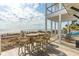 Inviting beachfront deck with tables and seating, offering stunning ocean views and relaxing outdoor living at 511 W Ashley Ave, Folly Beach, SC 29439