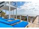 Outdoor deck with blue chaise lounges overlooking the beach and the ocean at 511 W Ashley Ave, Folly Beach, SC 29439