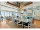 Spacious dining area with open-concept design, featuring a stylish chandelier, a view of the ocean, and modern kitchen at 511 W Ashley Ave, Folly Beach, SC 29439