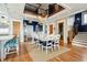 Well-lit dining room with modern chandelier, a large table, and stylish blue accents, ideal for Gathering meals and entertaining at 511 W Ashley Ave, Folly Beach, SC 29439