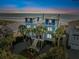 Charming, multi-story beach home with lush landscaping, stairs, and scenic ocean views at 511 W Ashley Ave, Folly Beach, SC 29439