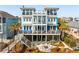 Stunning coastal home featuring multi-level decks, a fire pit, and panoramic ocean views, perfect for luxurious outdoor living at 511 W Ashley Ave, Folly Beach, SC 29439