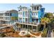Beautiful multi-story home with spacious decks, outdoor seating, and a cozy fire pit, ideal for entertaining and relaxing at 511 W Ashley Ave, Folly Beach, SC 29439