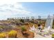 Picturesque outdoor fire pit area with seating surrounded by lush vegetation and a charming boardwalk backdrop at 511 W Ashley Ave, Folly Beach, SC 29439