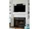Living room fireplace with a black marble surround and custom white built-in shelving at 511 W Ashley Ave, Folly Beach, SC 29439