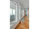 Hallway with natural light leads to the bedroom, has hardwood floors, and has access to a covered deck with lounge chairs at 511 W Ashley Ave, Folly Beach, SC 29439