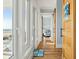 Bright hallway featuring hardwood floors, white walls and ocean views at 511 W Ashley Ave, Folly Beach, SC 29439