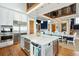 Open concept kitchen and dining area with a marble island, stainless steel appliances, and wooden floors at 511 W Ashley Ave, Folly Beach, SC 29439
