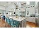 Spacious open concept kitchen with large island, pendant lighting, stainless steel appliances, and bar seating at 511 W Ashley Ave, Folly Beach, SC 29439