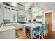 Bright kitchen features a large island, stainless steel appliances, designer backsplash, and a wooden floor at 511 W Ashley Ave, Folly Beach, SC 29439