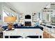 Bright living room with fireplace, built in shelves and adjacent kitchen with bar seating at 511 W Ashley Ave, Folly Beach, SC 29439