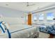 Light filled main bedroom with ocean views, window seat, and white wood accents at 511 W Ashley Ave, Folly Beach, SC 29439