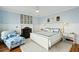 Bright main bedroom with white wood furniture, fireplace, and cozy sitting area at 511 W Ashley Ave, Folly Beach, SC 29439