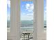 Ocean view through open doors to patio, featuring beach with pedestrian at 511 W Ashley Ave, Folly Beach, SC 29439
