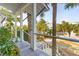 Charming porch area with sturdy wood railing and calming neighborhood views surrounded by lush green trees and landscaping at 511 W Ashley Ave, Folly Beach, SC 29439