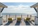 Three lounge chairs on rooftop deck with ocean views at 511 W Ashley Ave, Folly Beach, SC 29439