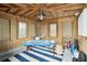 Interior view of room with wood paneled walls and ceiling, and massage table at 511 W Ashley Ave, Folly Beach, SC 29439