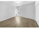 An empty bedroom with light hardwood floors, bright white walls, a large window, and a closet at 5509 Copper Trce, North Charleston, SC 29418