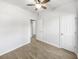 This empty bedroom has light hardwood floors, bright white walls and a ceiling fan at 5509 Copper Trce, North Charleston, SC 29418