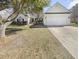 Charming one-story home features an attached two-car garage, well-maintained lawn, and mature trees at 5509 Copper Trce, North Charleston, SC 29418