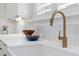 Close-up of a kitchen sink with modern fixtures, countertop, and bright window at 610 Daggett St, Daniel Island, SC 29492