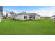 Expansive backyard with lush green lawn and a view of the home's exterior and covered patio at 642 Cottage Landing Dr, Summerville, SC 29485
