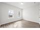 Well-lit bedroom with hardwood floors and two windows with outside view at 642 Cottage Landing Dr, Summerville, SC 29485