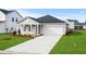 Charming single-story home with a well-manicured lawn and attached garage at 642 Cottage Landing Dr, Summerville, SC 29485