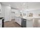 Bright kitchen featuring white cabinets, stainless steel appliances, and a large island with pendant lighting at 642 Cottage Landing Dr, Summerville, SC 29485