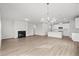 Open-concept living room with hardwood floors, a fireplace, and views into the kitchen at 642 Cottage Landing Dr, Summerville, SC 29485
