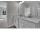 Bathroom featuring double vanity sinks, stone countertops, stainless steel fixtures and ample lighting at 642 Cottage Landing Dr, Summerville, SC 29485