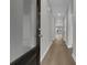 Bright hallway with wood floors leads to a welcoming space filled with natural light and neutral wall paint at 642 Cottage Landing Dr, Summerville, SC 29485