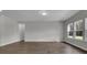 Spacious living room with wood floors, neutral paint, natural light, and a view of the outdoor greenery at 642 Cottage Landing Dr, Summerville, SC 29485