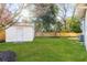 Private fenced backyard with lush green grass and storage shed, ready for outdoor enjoyment at 704 N Godfrey Park Pl, Charleston, SC 29407