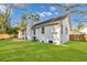 Backyard with lush green grass and mature trees, perfect for outdoor relaxation at 704 N Godfrey Park Pl, Charleston, SC 29407
