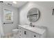 Bathroom featuring a modern vanity, round mirror, and updated fixtures at 704 N Godfrey Park Pl, Charleston, SC 29407