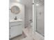 Bathroom showcasing a modern vanity, round mirror, and glass-enclosed shower at 704 N Godfrey Park Pl, Charleston, SC 29407
